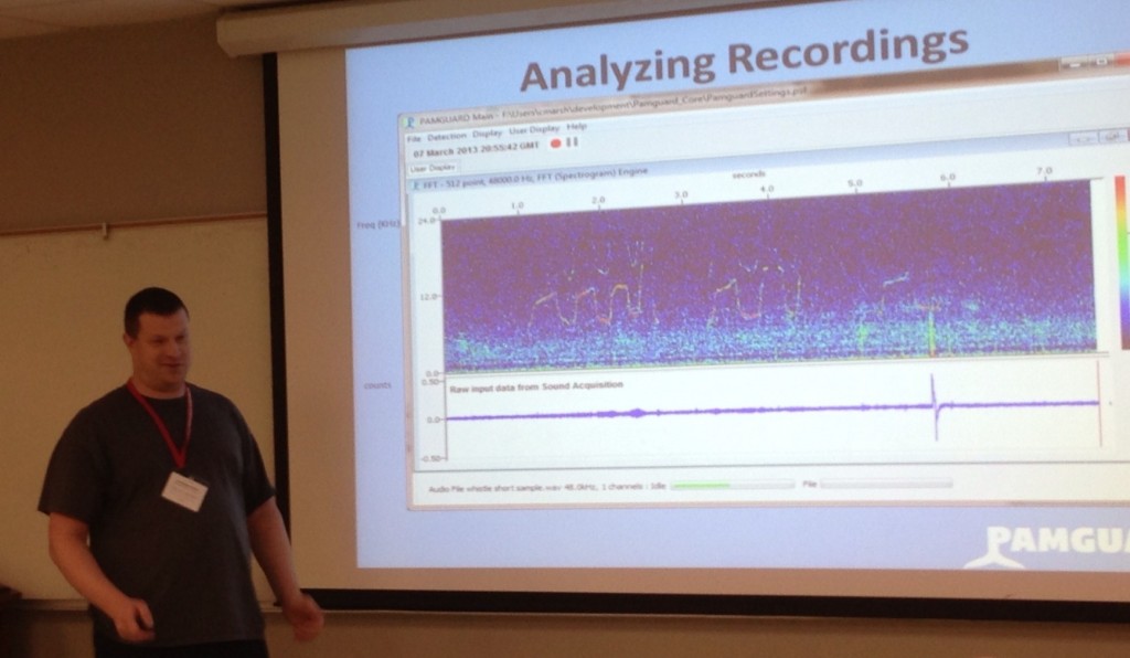 Chris March at front of classroom presenting research