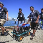 Members of the Mechatronics Club members move "Defiance"to the competition pool